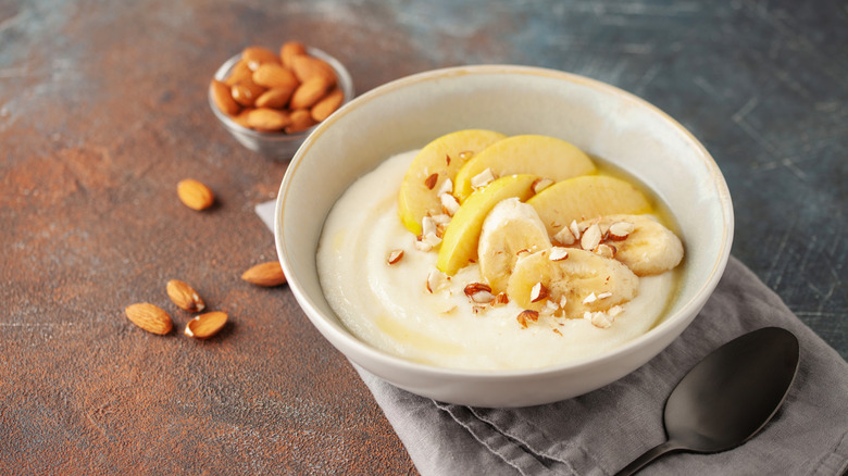 A bowl of banana salad sprinkled with almonds
