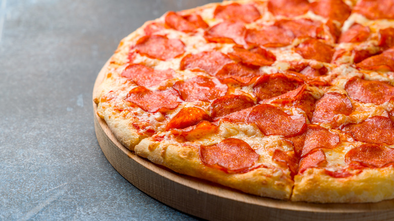 A pepperoni pizza on a counter