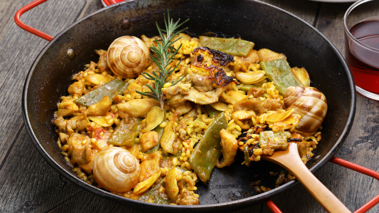 Traditional Spanish paella in a black pan