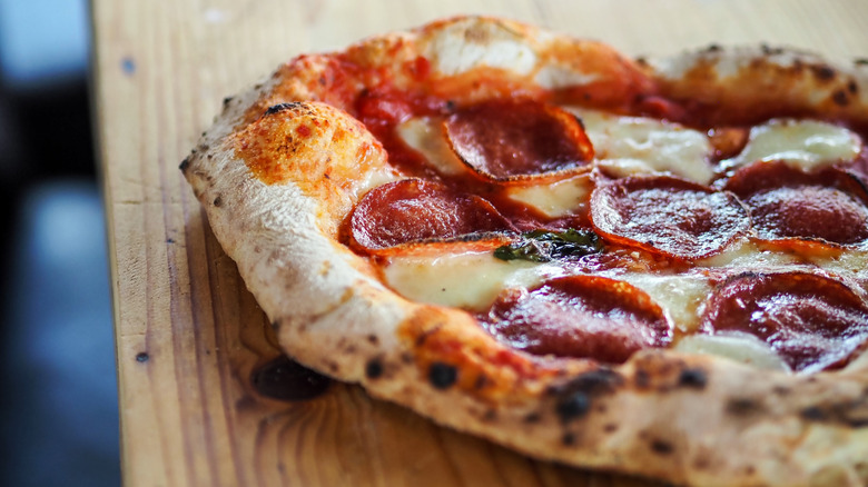 Close up of pizza with crispy pepperoni on top