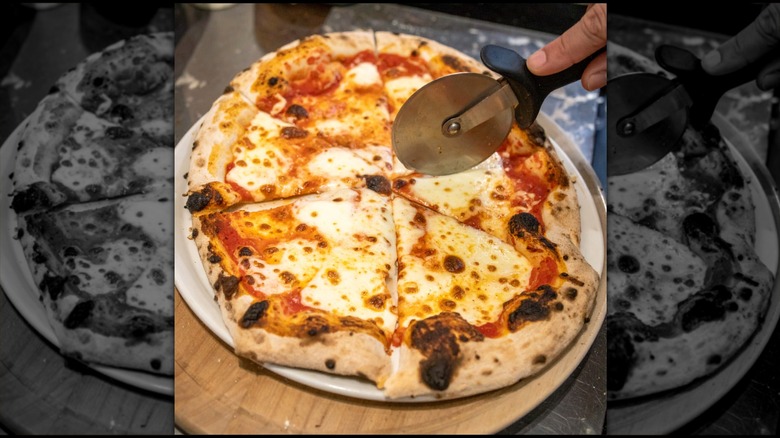 Margherita pizza with black, blistered sections around the crust