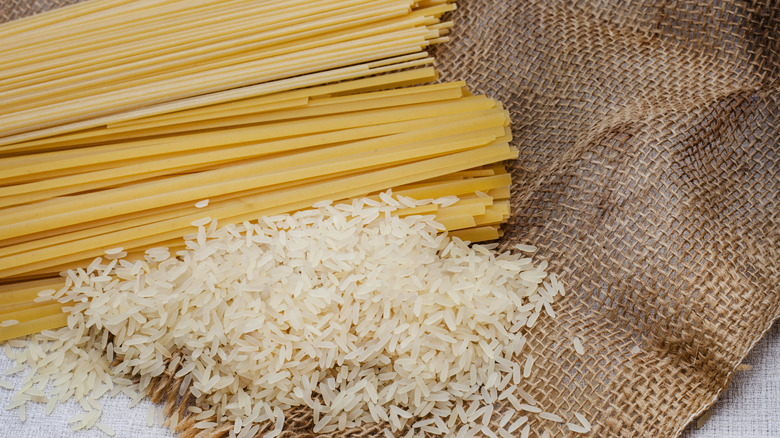 strands of raw pasta and grains of rice