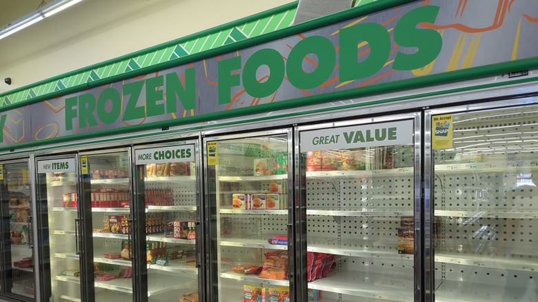 The frozen food section at a Dollar Tree with sparsely stocked shelves - signs proclaim New Items, More Choices, and Great Value