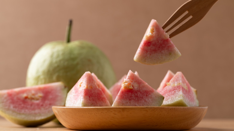 cut red guava on a fork