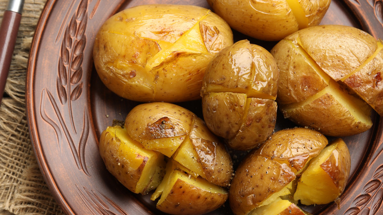 Baked potatoes with crosshatch slices