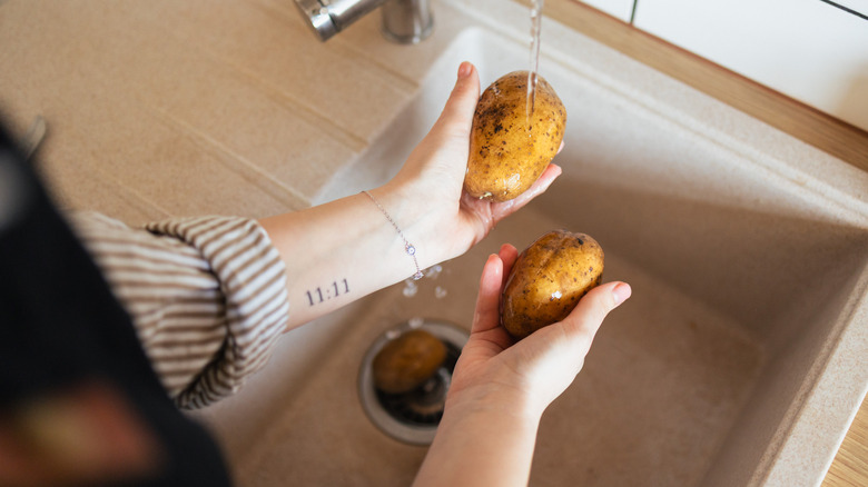 Washing potatoes in a sink