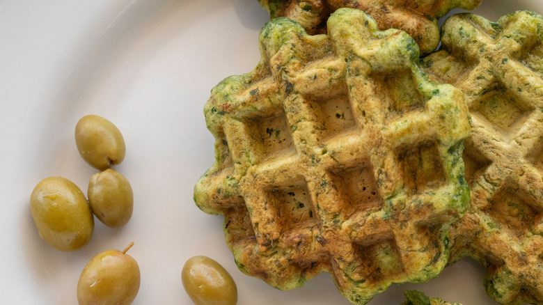 Waffles with green olives on a plate