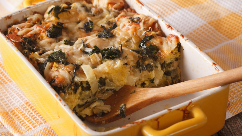 Breakfast strata in a dish with a spoon