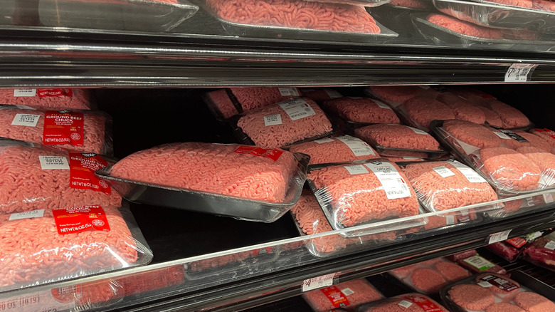 Ground beef piled on shelves in a grocery store