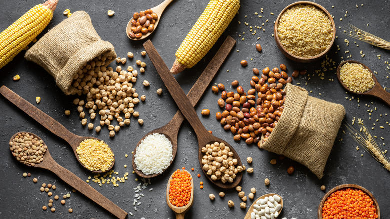 Dry lentils, beans, rice, and other good arranged picturesquely on a black background