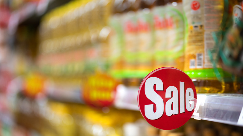 The sale shelf at a grocery store, labeled with a red sign