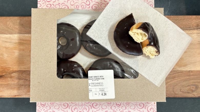 Walmart chocolate donut half on wax paper on top of box