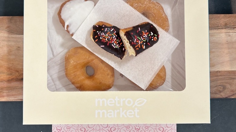 Metro Market Chocolate Long John cut in half on wax paper on package of assorted