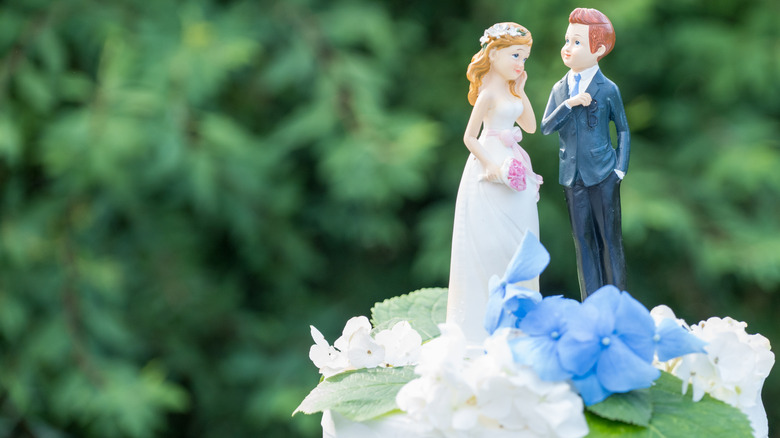 Two figurines in a wedding cake topper