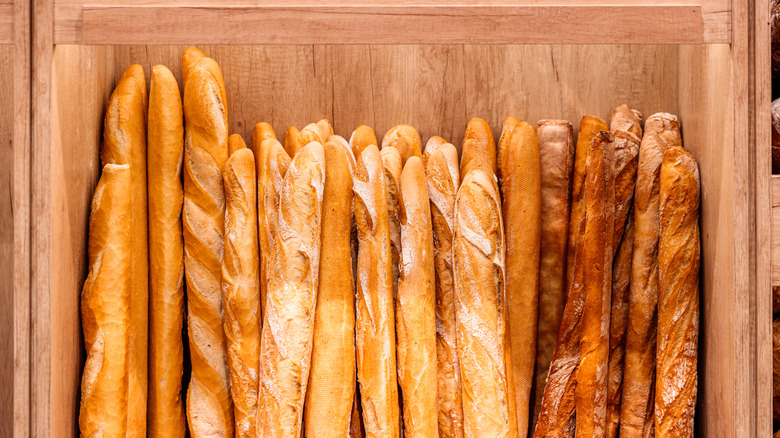 A wooden box containing various types of baguettes