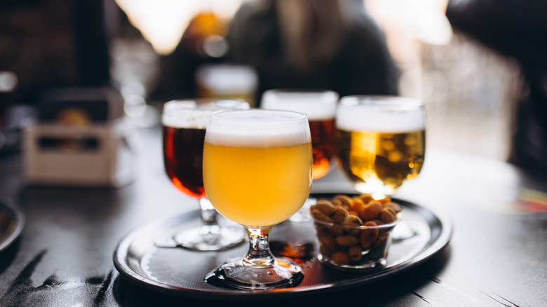 Various beers in chalices served on a tray