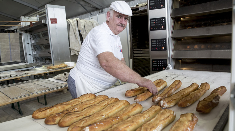 A man making baguettes