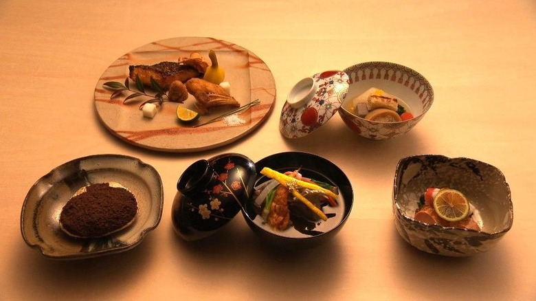 A preparation of washoku, with various small dishes placed in ornate china vessels