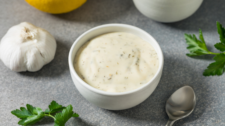 A bowl of ranch dressing on a counter