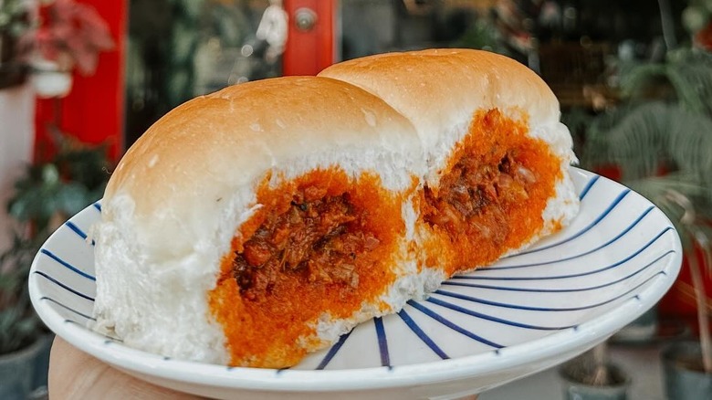 A person holding a plate of choris pao