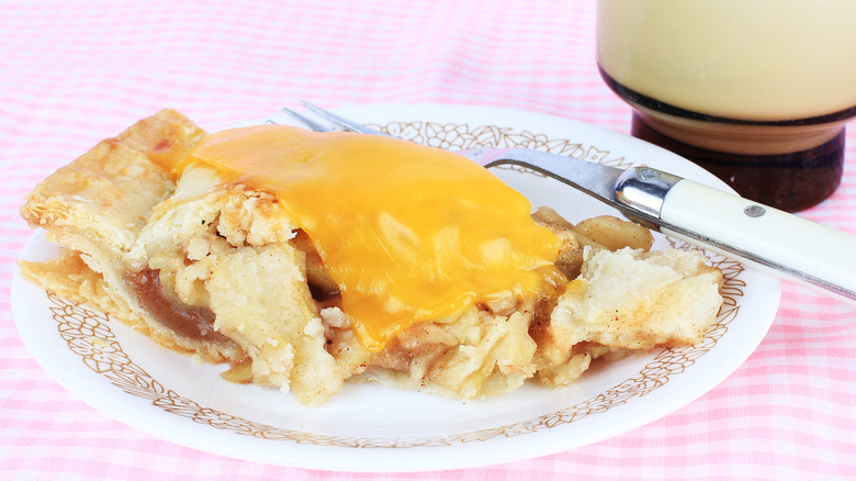 A bit of cheese is melted atop a slice of apple pie