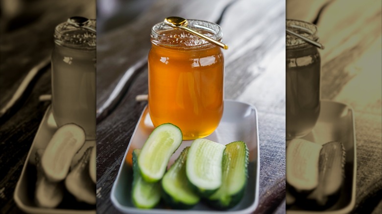 jar of honey plated behind sliced up pickles