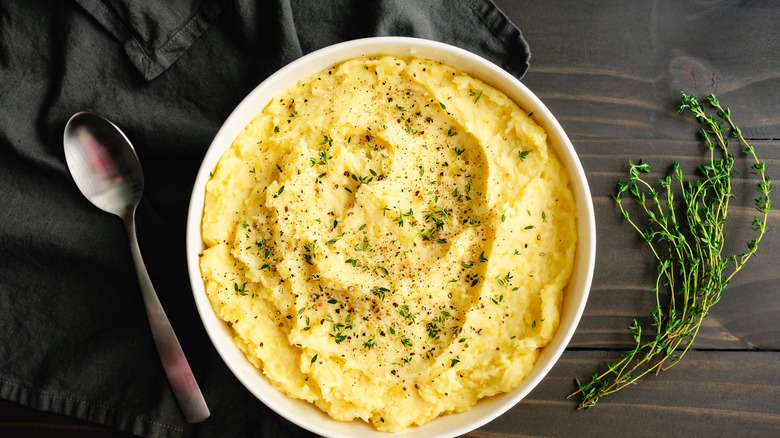 Bowl of mashed potatoes with thyme