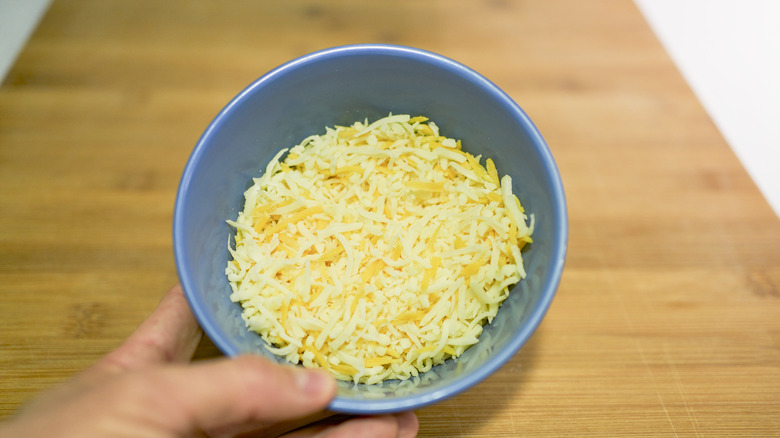 Blue bowl of grated cheese