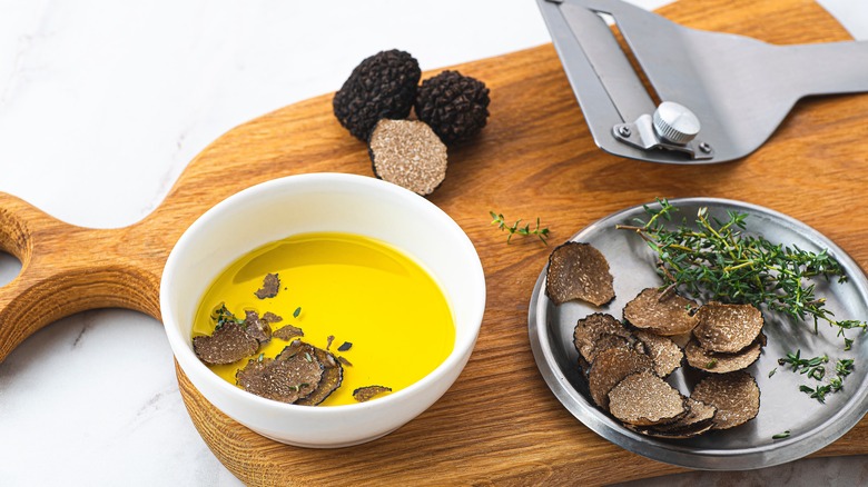 Olive oil in a bowl with black truffles