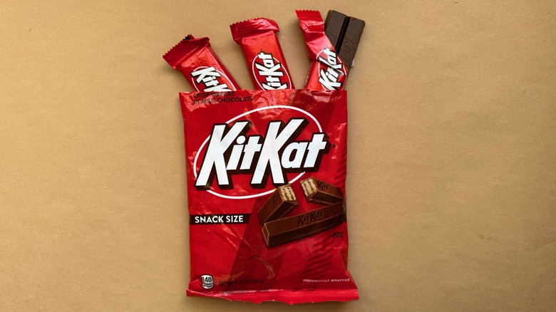 Opened bag of Kit Kats with individually wrapped pieces coming out of it