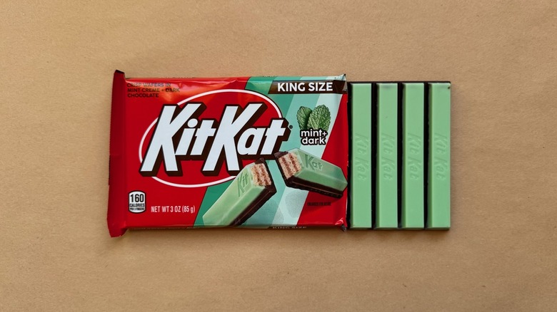 Opened bar of Mint + Dark Kit Kat on brown surface