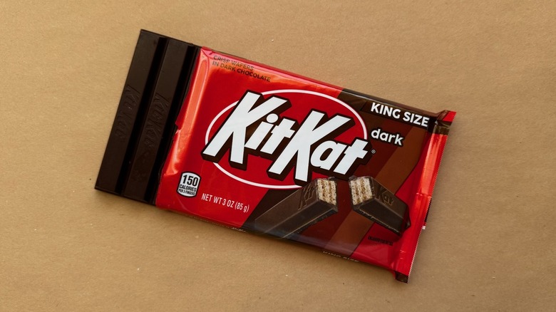 Opened bar of Dark Kit Kat on brown surface