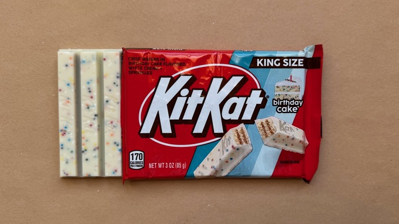 Opened bar of Birthday Cake Kit Kat on brown surface