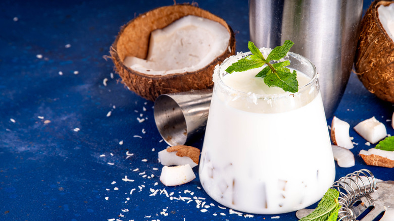 A coconut cocktail garnished with mint