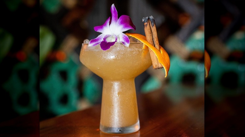 A Nui Nui cocktail garnished with an orchid