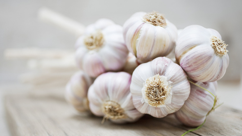 Several bulbs of garlic on a table.