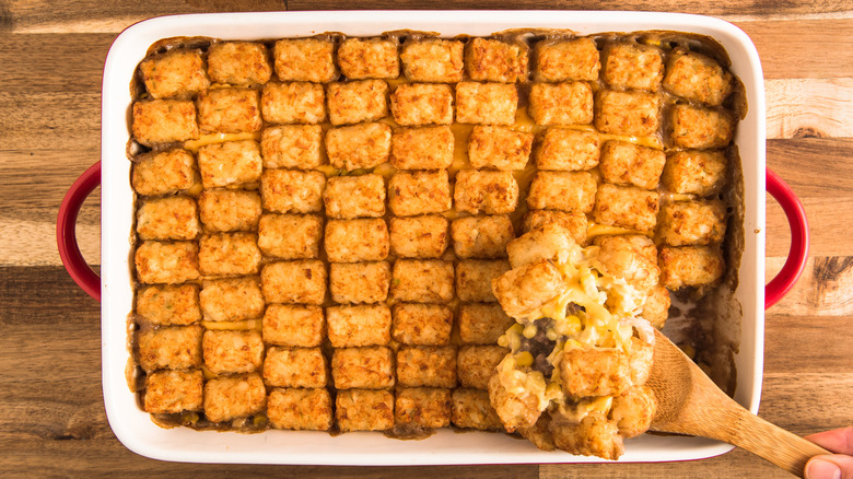 Spoon scooping a serving out of a tater tot hot dish