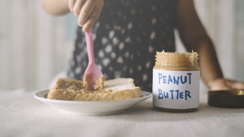 Girl spreading peanut butter