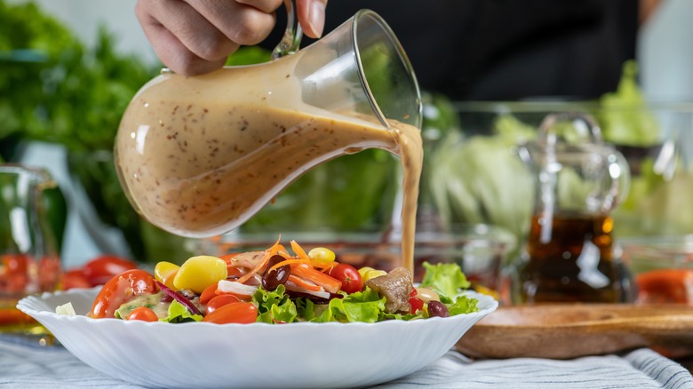 Salad dressing poured on salad