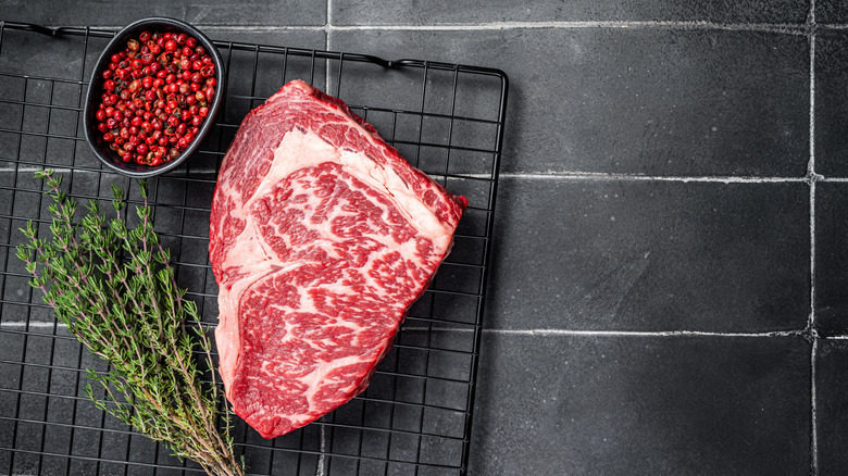 Ribeye steak with marbling on wire rack