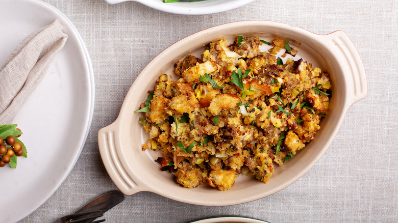 Cornbread stuffing in a white, oval baking dish