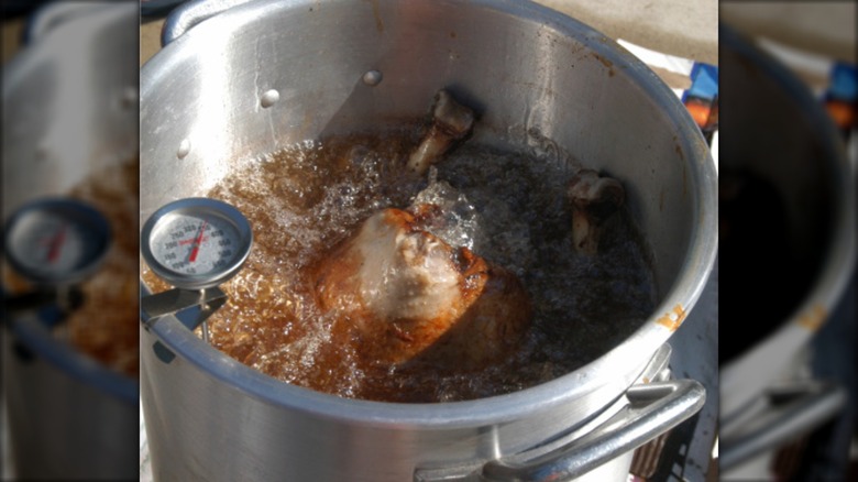Turkey frying in oil with thermometer