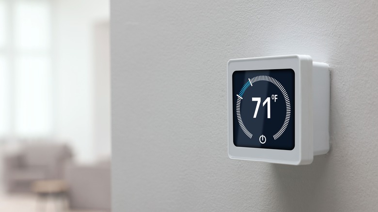 digital thermostat on wall showing 71 degrees