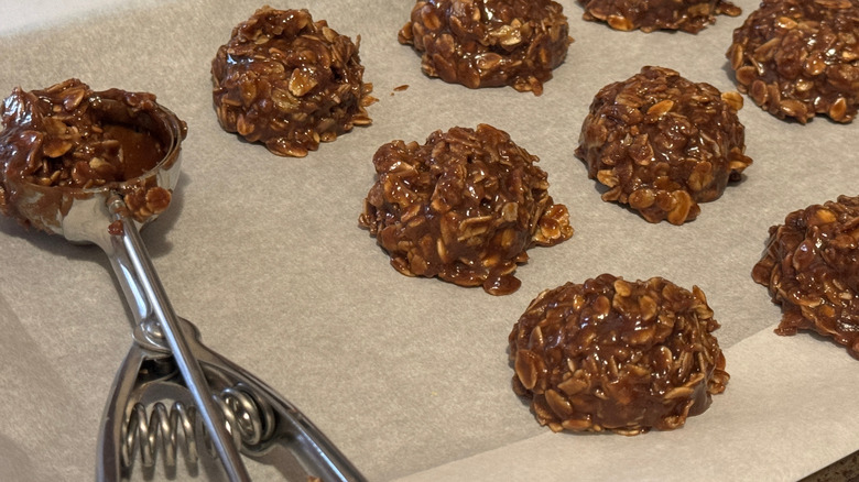 No-bake cookies on wax paper with a scoop