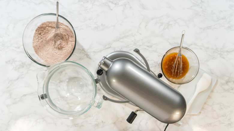 An overhead view of ingredients and a stand mixer