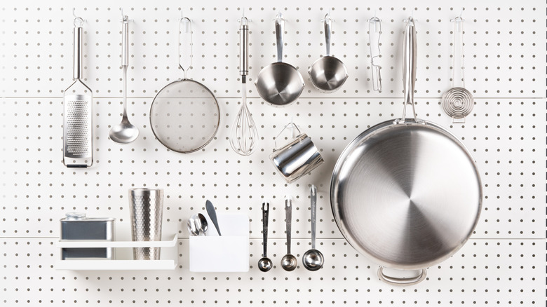 Stainless steel implements hanging on a pegboard