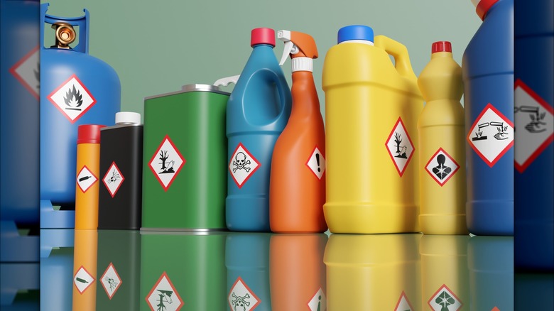 Several bright coloured and non-branded cleaning product bottles are lined up next to each other. Each bottle has a danger warning image on the exterior.