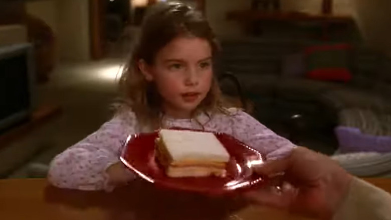 Bebe with a sandwich on a plate