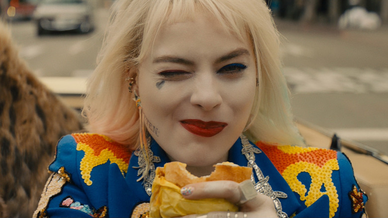 Harley Quinn holding a sandwich