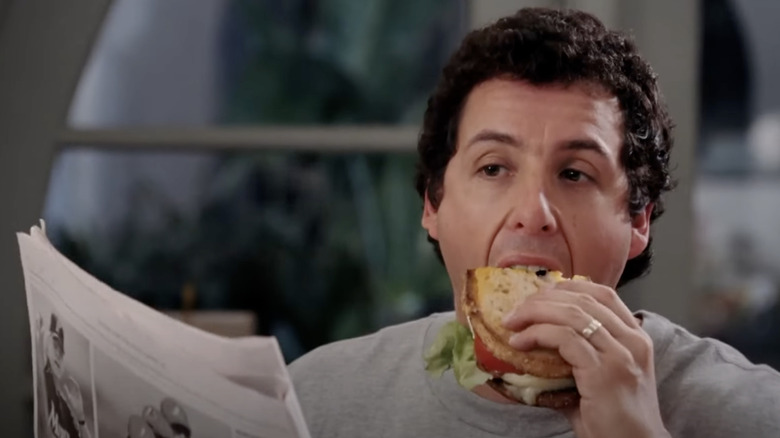 Adam Sandler biting into a sandwich in the film "Spanglish"